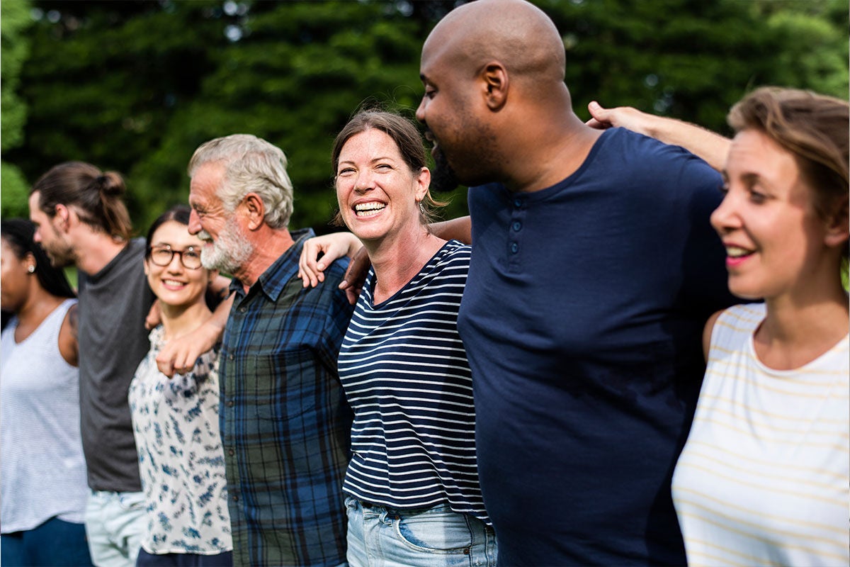 community of people arms around each other community of people arms around each other