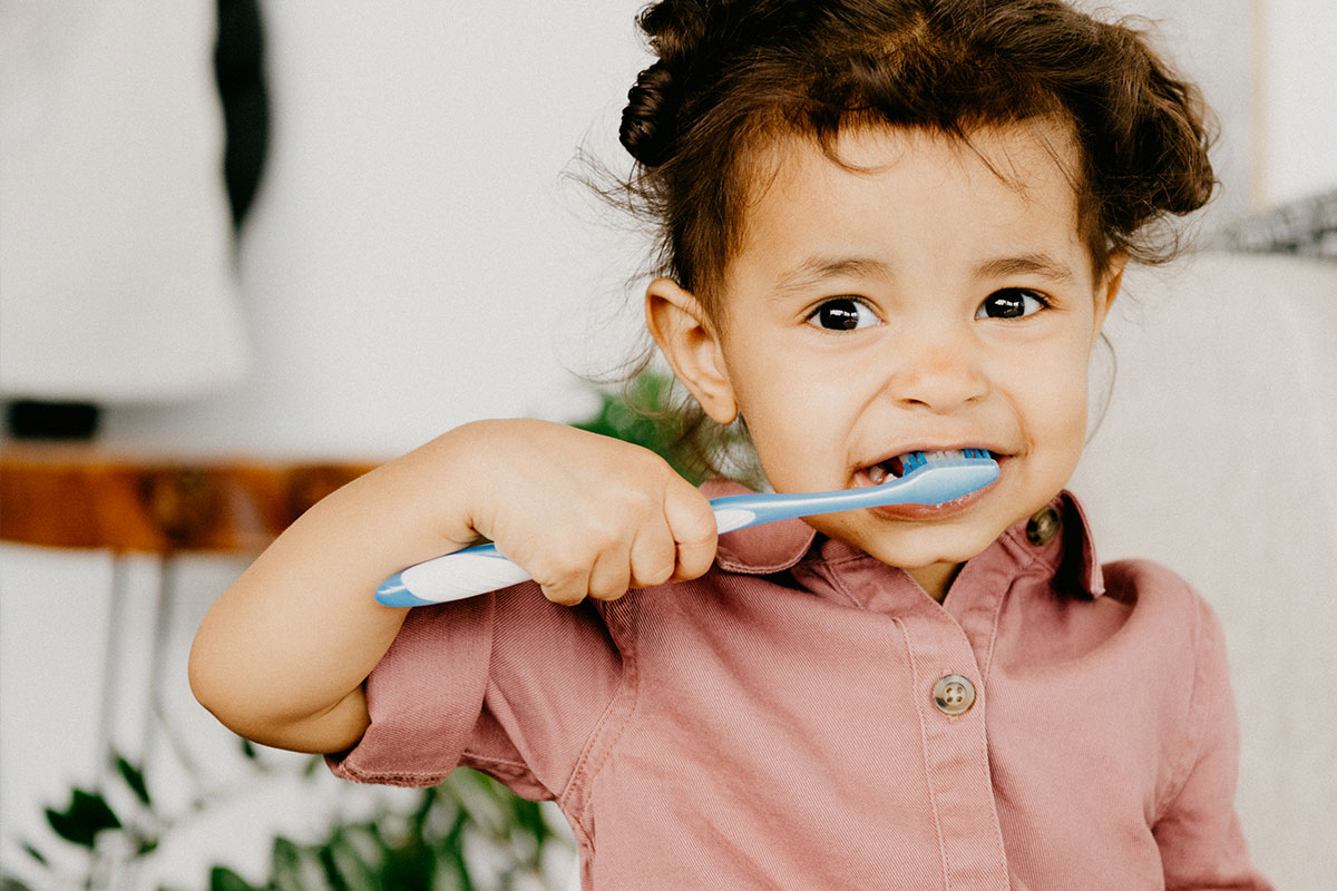 Girl in pink brushing teeth Girl in pink brushing teeth